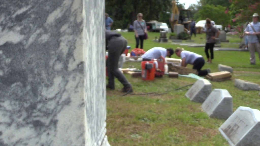 Conservationists working to maintain a headstone at Riverside Cemetery in Macon.